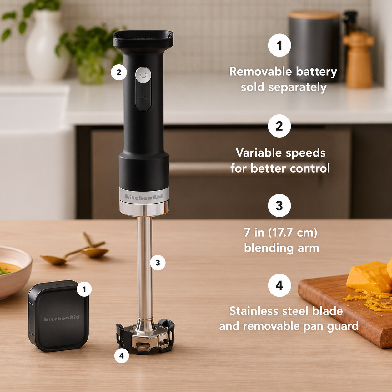 An immersion blender shown on a kitchen countertop with overlaid numbered callouts explaining features: removable battery sold separately, variable speeds for better control, 7 in (17.7 cm) blending arm, and stainless steel blade and removable pan guard.